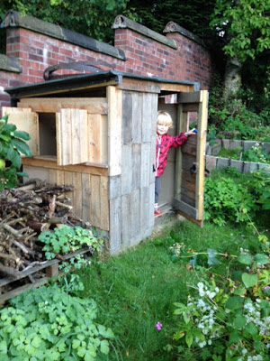 Euan in his wonderful, upcycled playhouse