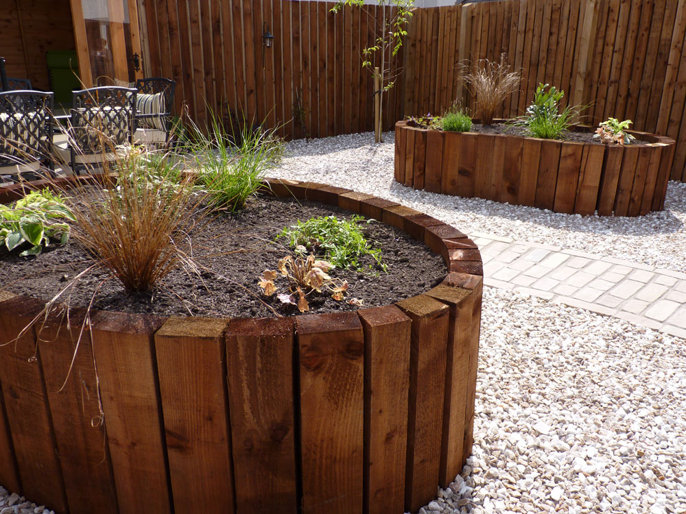 We designed & built these lovely curving raised beds