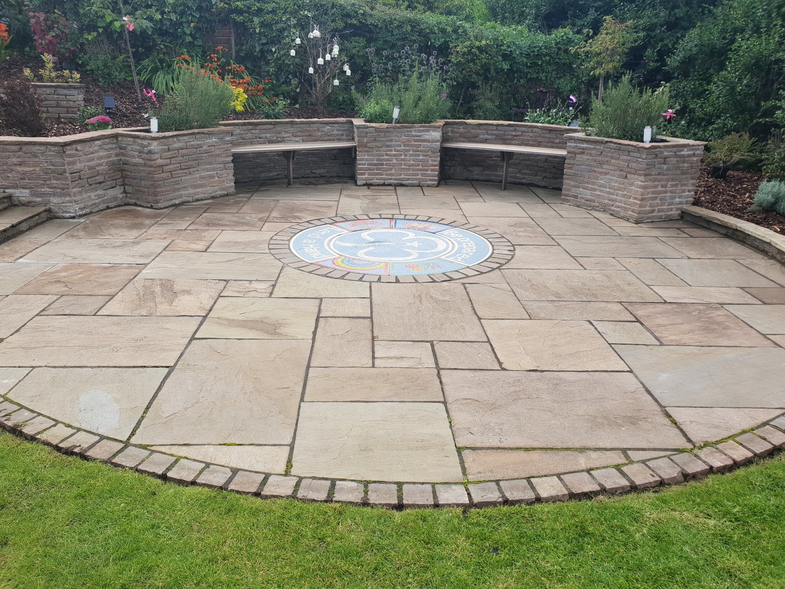 Sandstone patio with inset mosaic