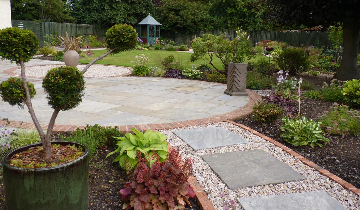 An eclectic mix of pots can work well in a garden to create features in different areas