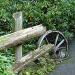 This upcycled wheel makes a great handrail in a garden in Canada