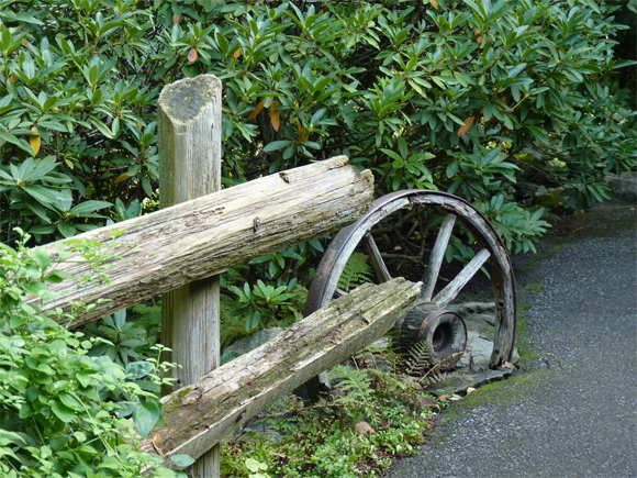 This upcycled wheel makes a great handrail in a garden in Canada