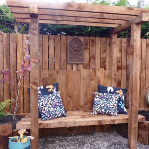 A bespoke arbour can be a lovely central feature of a garden]