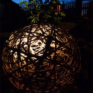 A willow ball with lighting set inside creates a wonderful focal point at night time