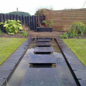 Here, the water feature and metal globe draw the eye up to the beautiful views beyond