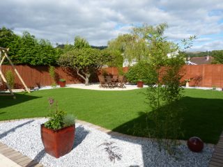 Curving lawn, a new patio and structural planting transforms this garden