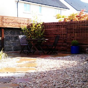 contemporary fencing encloses this garden whilst still exposing the historic wall