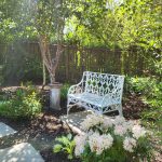 A metal bench in a garden we designed & built