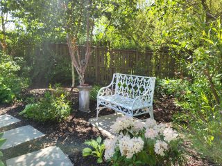A metal bench in a garden we designed & built