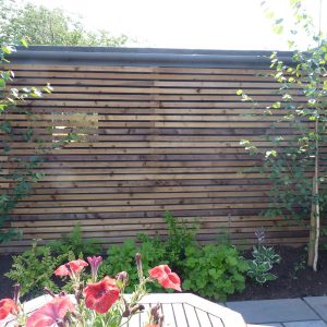 The timber screen disguises the unattractive garage wall