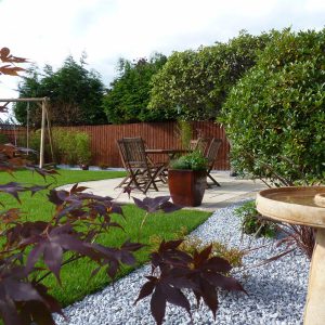 Bird baths, decorative balls and planters add interest to the gravel