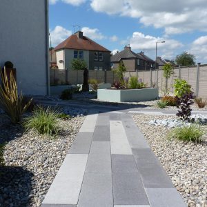 The planked paving leads you round the garden