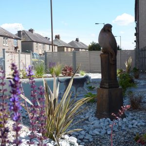 The eagle sculpture surrounded by planting