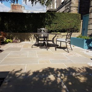 The sandstone paving with brick detailing