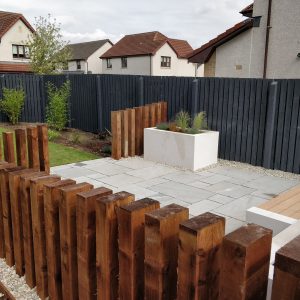 Chunky sleepers around the patio create an outdoor room