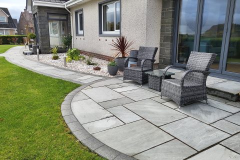 The new curving sandstone patio