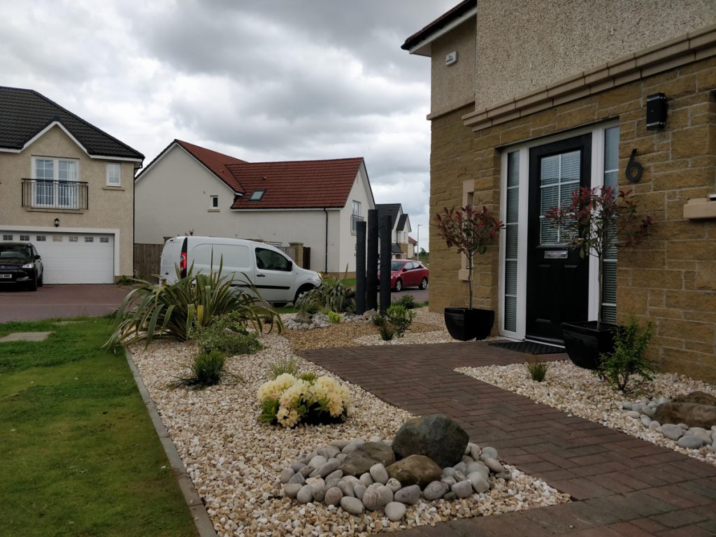 This front garden in Larbert has a lovely combination of gravel, cobbles, chunky timbers and planting. 